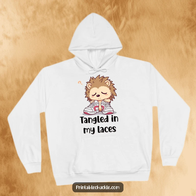 Funny hedgehog hoodie depicting a sleepy character confusedly trying on oversized sneakers, perfect for staying warm.