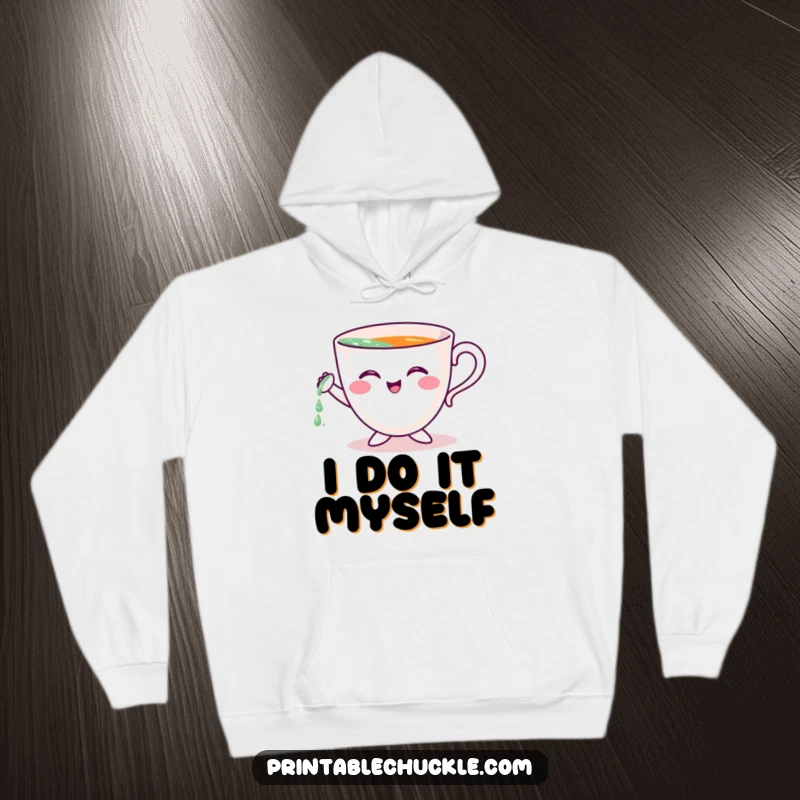 Funny hoodie featuring a cheerful teacup character adorably attempting to pour itself, perfect for cozy, humorous moments.