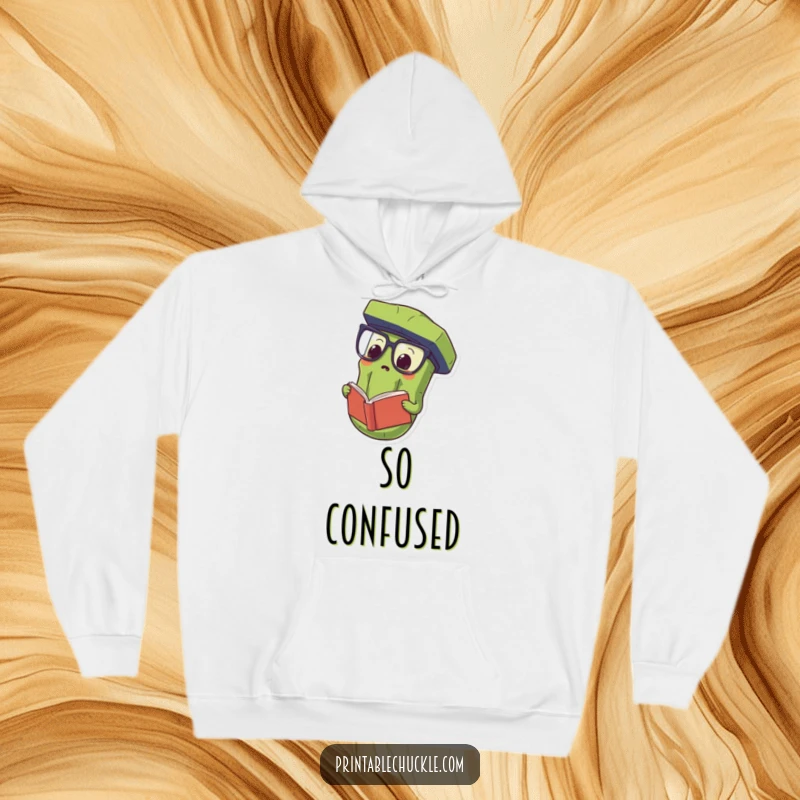 Funny Hoodie showing a proud pickle wearing oversized spectacles and reading a book upside down, offering warmth and smart humor.