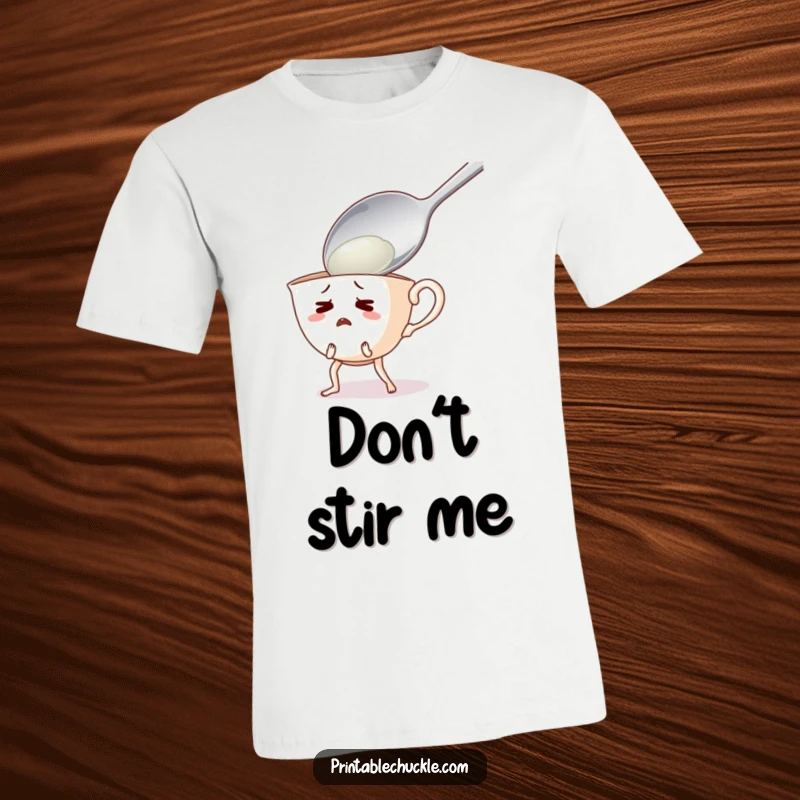 Funny t-shirt depicting a startled teacup character with legs flailing, attempting to escape a looming giant spoon.